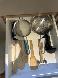 a drawer filled with lots of kitchen utensils at LOFTS CARIJOS CENTRO BH in Belo Horizonte