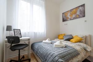 a bedroom with a bed with a desk and a chair at Train 23 in Belgrade