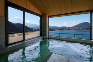 a swimming pool with a view of a mountain at Hotel Asafuji in Fujikawaguchiko