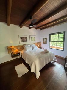 a bedroom with a large bed and a window at Pousada Motta in Miguel Pereira