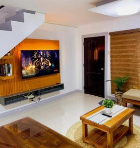 a living room with a tv on a wall at 2 Bedroom Townhouse- Near Clark Airport in Angeles