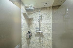 a shower in a bathroom with a glass door at From H Oceanpalace Hotel Jeju in Seogwipo