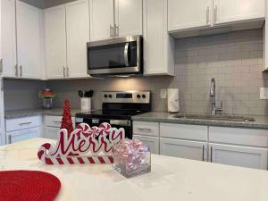 a kitchen with a christmas sign on the counter at Modern 1br - 15 from Airport in Stockbridge