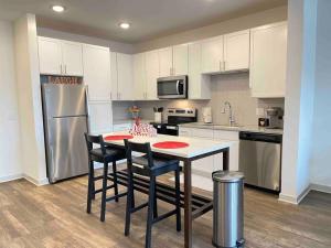 a kitchen with a table and chairs and a refrigerator at Modern 1br - 15 from Airport in Stockbridge