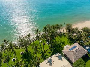 an aerial view of the beach and the ocean at ABSOLUTE BEACH FRONT MACKAY - Blue Pacific in Mackay