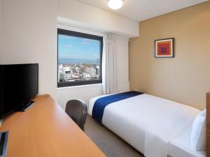 Postel nebo postele na pokoji v ubytování Art Hotel Niigata Station