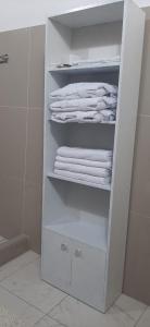 a white towel rack with towels in a bathroom at Hotel Casablanca in Ollantaytambo