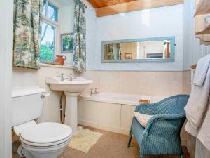 a bathroom with a toilet and a sink and a tub at Hallowarren Barn in Saint Anthony