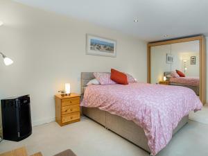 a bedroom with a bed and a large mirror at Oversands in Torquay