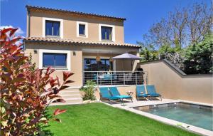 a house with two chairs and a swimming pool at La Maison Adriel in Saumane-de-Vaucluse