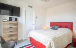 a bedroom with a bed and a dresser with a television at Lovely Home In Cartagena With Kitchen in Cartagena