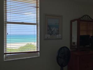 a room with a window with a view of the ocean at Pavilion Beach Front Apartment with Balcony in Miami Beach