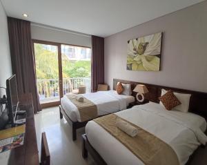 Postel nebo postele na pokoji v ubytování Abian Harmony Hotel
