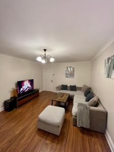 a living room with two couches and a flat screen tv at Entire 3 bedroom end of terrace house! in Thamesmead