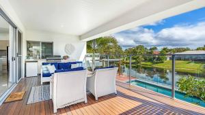 an open deck with a view of the water at Cabarita Reef House - Pool, Lake, Beach & AC! in Cabarita Beach