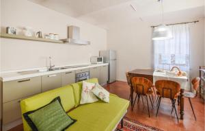 a living room with a yellow couch and a table at Amazing Apartment In Montegrosso Dasti With Kitchen in Montegrosso dʼAsti