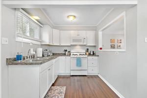 a white kitchen with white cabinets and a sink at 127 Oakwood Hills in Oakwood Hills