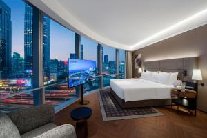 Voodi või voodid majutusasutuse Intercity Hotel Futian Bin He Zhongzhou Bay toas