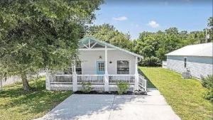 a white house with a porch and a yard at 2 St Augustine in Saint Augustine