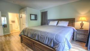 a bedroom with a large bed with a wooden headboard at Bright 3BR Cottage near the Beach and Downtown in Saint Augustine