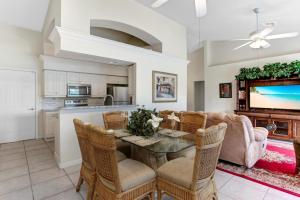 a kitchen and living room with a table and chairs at 1395 Marco Island in Marco Island