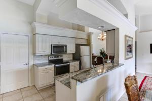 a kitchen with white cabinets and a counter top at 1395 Marco Island in Marco Island