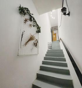 a stairway with green steps and plants on the wall at The Classy RomaAkar in Shah Alam