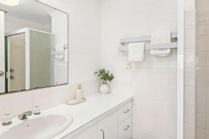 a white bathroom with a sink and a mirror at Seaspray Unit 3 4 Intrepid Close in Nelson Bay