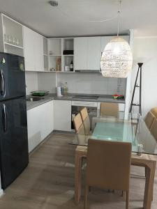 a kitchen with a glass table and a dining room at Lomas de Puyai in Agua Salada