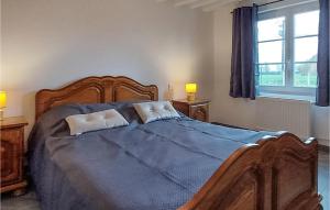 a bedroom with a large wooden bed with two pillows at Lovely Home In Berthouville With Kitchen in Berthouville