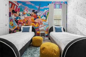 2 camas en una habitación con un mural de ratón Mickey en Elegant Disney Vacation Home on Reunion Resort en Kissimmee