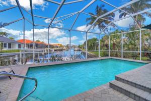 a swimming pool at a resort with a glass ceiling at 80 Marco Island in Marco Island