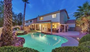 a house with a swimming pool in front of it at Seven Palms in Henderson