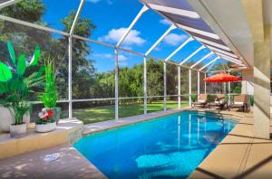 a swimming pool in a house with a large window at 72 Marco Island in Marco Island
