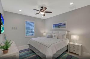 a bedroom with a bed and a ceiling fan at 4BR Beach House Private Pool Minutes to Beach in Marco Island +22 photos