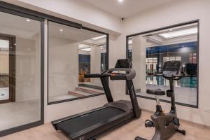 a gym with two elliptical machines and a window at Pranakorn Heritage Hotel in Bangkok