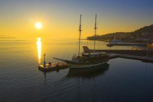 a boat is docked in the water at sunset at Apartments by the sea Tkon, Pasman - 19017 in Tkon