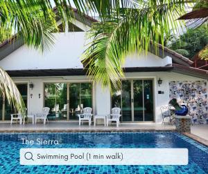 une villa avec une piscine au bord de la piscine Sterko dans l'établissement Sierra Hostel, à Nai Yang Beach