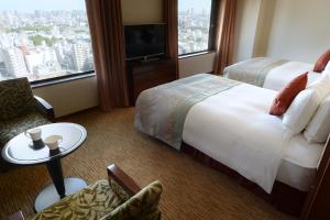 Postel nebo postele na pokoji v ubytování Hotel Metropolitan Tokyo Ikebukuro
