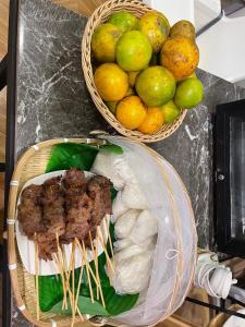 two baskets of meat and fruit on a counter at Nan Cozy House in Nan