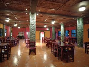 a restaurant with wooden tables and chairs in a room at El Castillo de Piedra in San Miguel