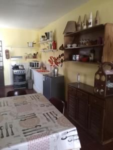 a kitchen with a table and a kitchen with a stove at Los Tilos in Colonia del Sacramento