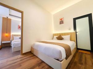 Postel nebo postele na pokoji v ubytování Torino Hotel Dalat