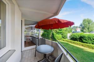 a balcony with a table and an umbrella at Beau Rivage Apt 9 in Scharbeutz