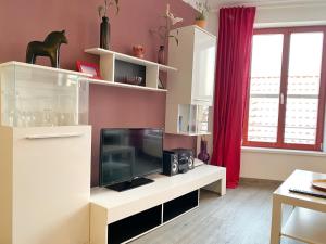 a living room with a television on a white entertainment center at Stralsund - Haus Gohr, Quartier 6 in Stralsund