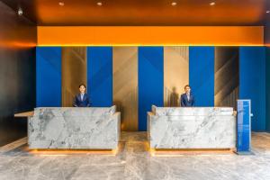 two men in suits standing on the stage at Holiday Inn Express Heze City Center, an IHG Hotel in Heze