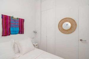 a white bathroom with a shower and a towel at Apartamento La Latina Palacio in Madrid