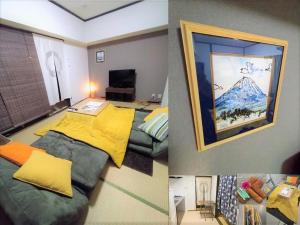 板橋 RCアネックス Rc306 في طوكيو: غرفة بسرير وصورة جبل
