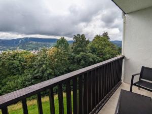 a balcony with a bench and a view of the mountains at Gîte Gérardmer, 1 pièce, 2 personnes - FR-1-589-621 in Gérardmer