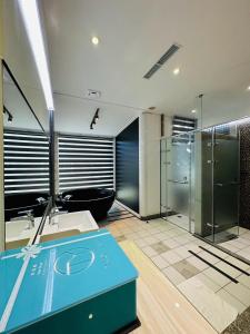 a bathroom with two sinks and a glass shower at TY Motel in Dayuan